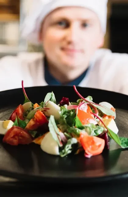 Chef holding a plate with food